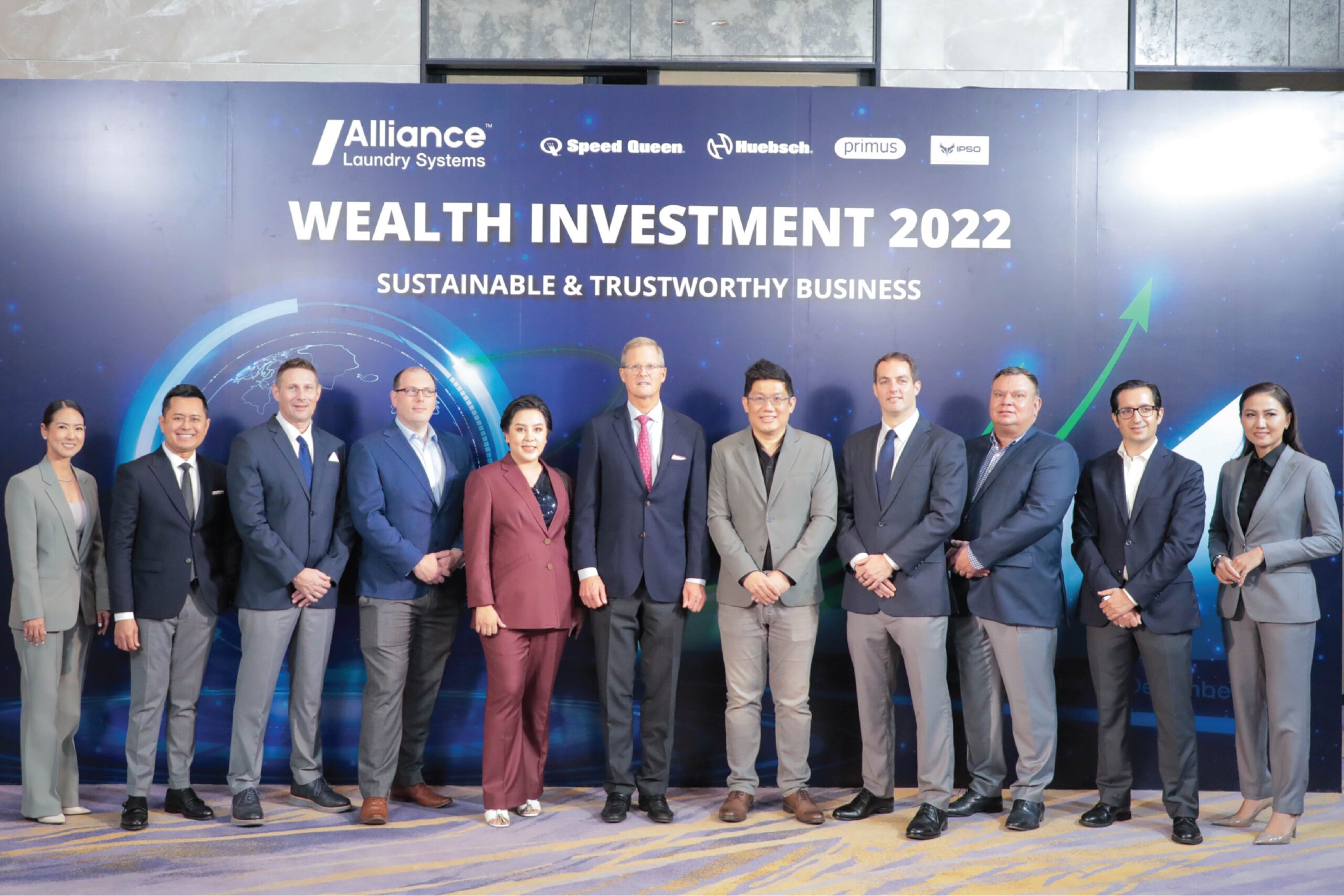Seven Men with Navy Blue Suit and one man with grey suit and two women with grey suit and one woman with red suit they stand from of Board Alliance Wealth Investment 2022